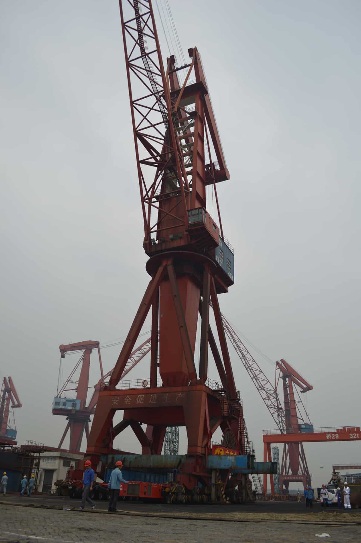 Portal crane transported with lifting boom