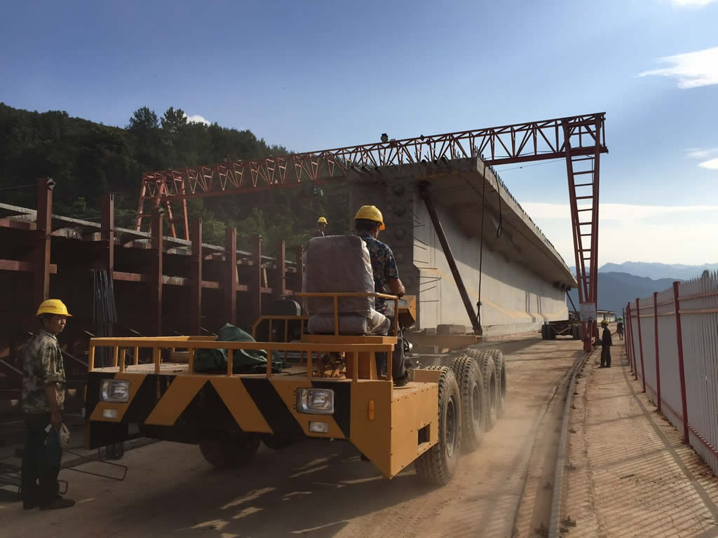 Precast bridge section transporter