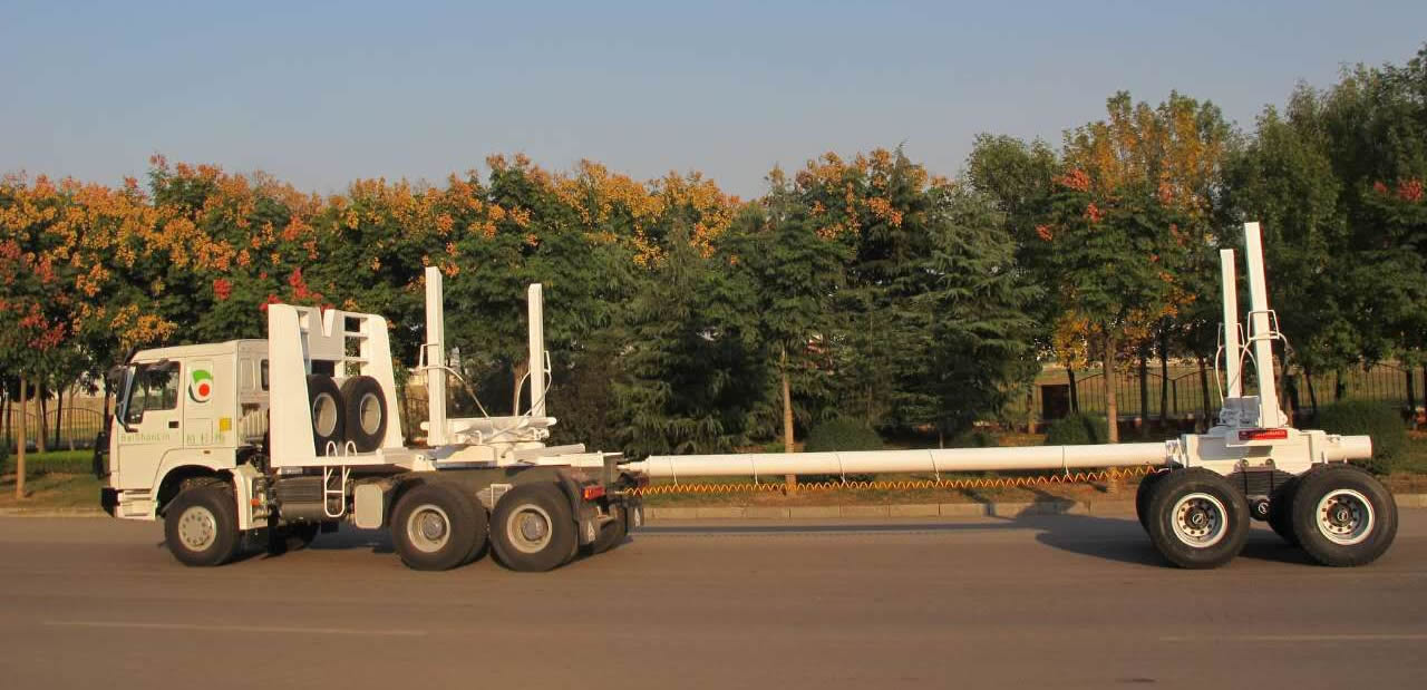 Timber trailer connected with tow-bar